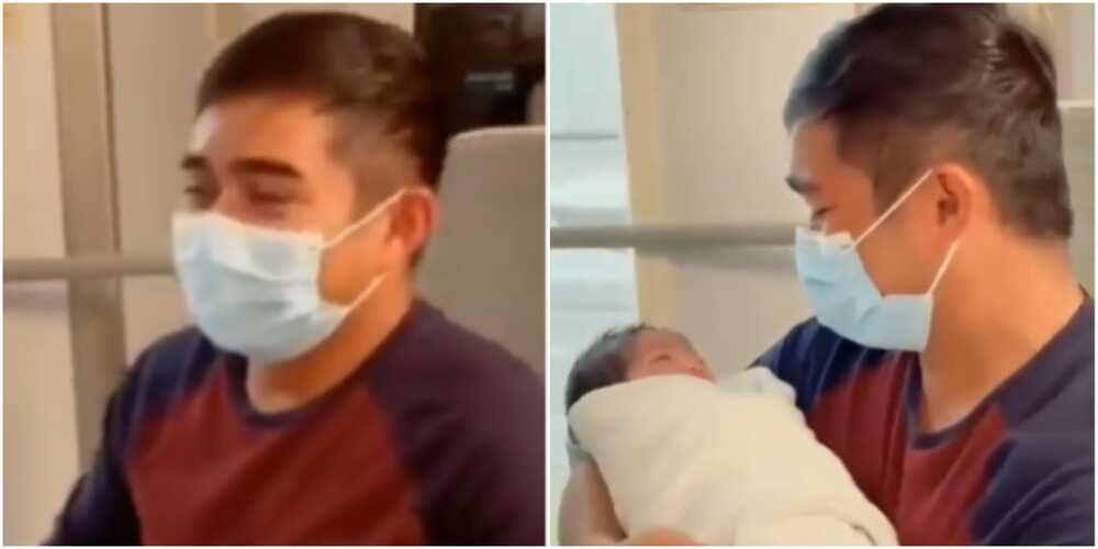 The father was emotional as he carried his baby for the first time