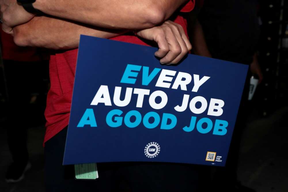 United Auto Workers members hold signs outside the Stellantis auto plant in Sterling Heights, Michigan, on July 12, 2023 United Auto Workers members hold signs outside the Stellantis auto plant in Sterling Heights, Michigan, on July 12, 2023