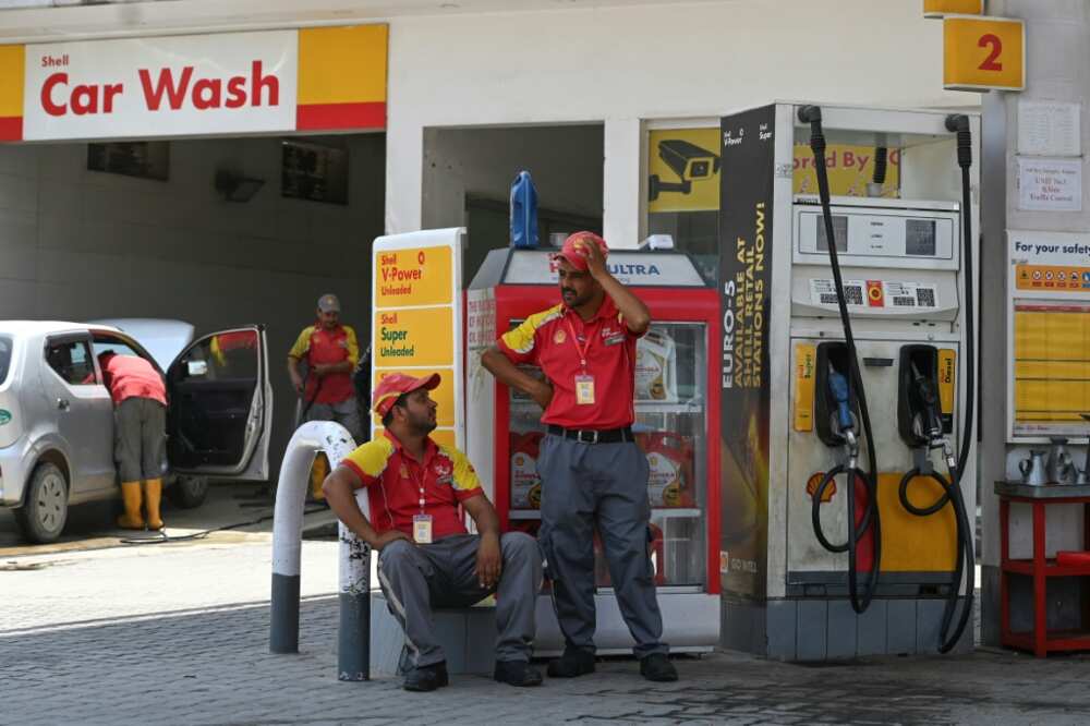 Attendants wait for customers at a petrol station in Rawalpindi on Friday. Soaring energy prices have been one of the biggest drivers of inflation in Pakistan