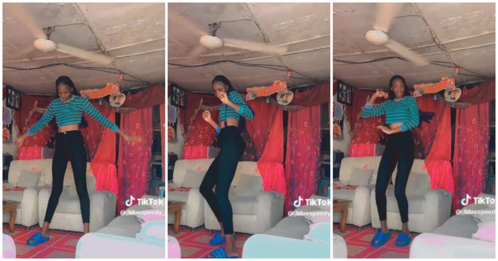Very tall Nigerian lady dances, fan, dad's humble home