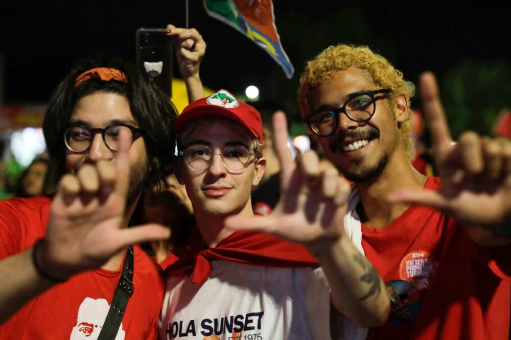 Supporters of former Brazilian president Luiz Inacio Lula da Silva make an 'L' sign with their hands, signalling support for Lula