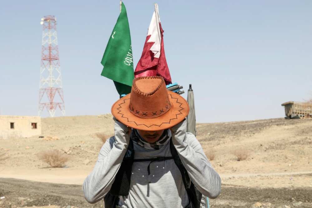 Saudi and Qatari flags on his backpack