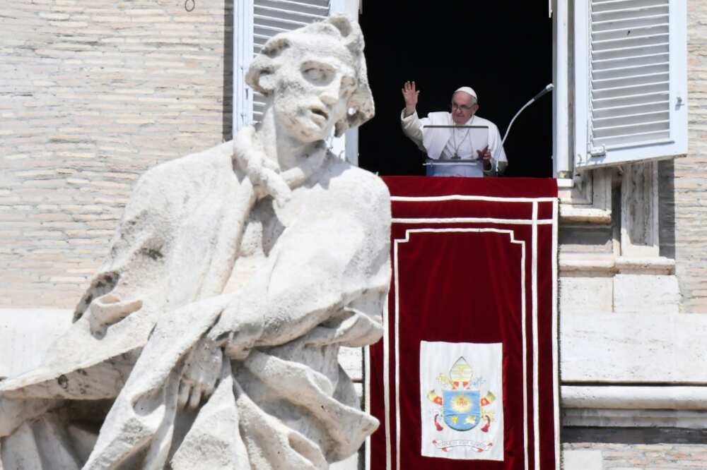 Pope Francis waves from the window of the apostolic palace on August 21, 2022 during the weekly Angelus prayer in The Vatican.