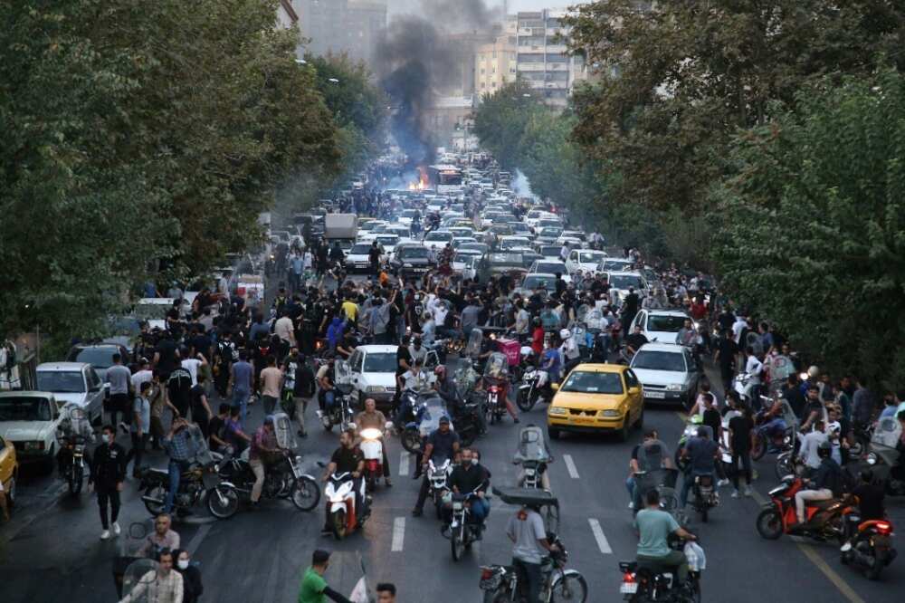 Motorists block a street in Tehran during the Amini protests
