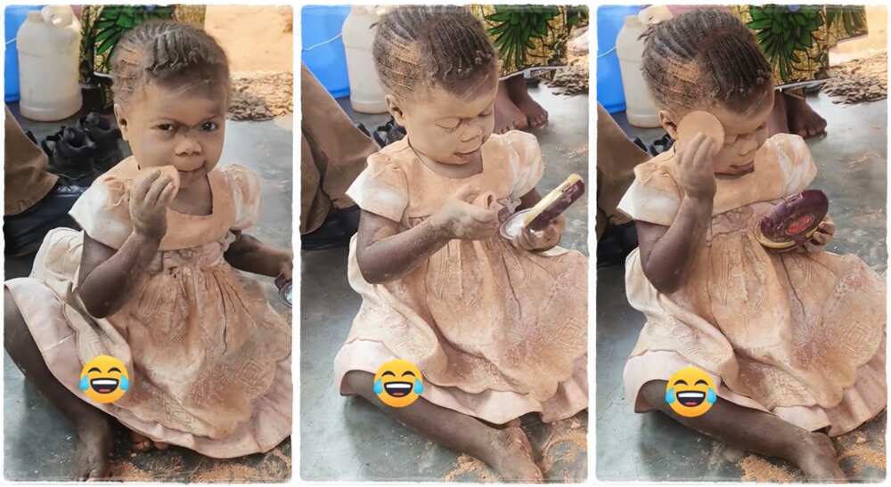 A little girl using pancake on her face.