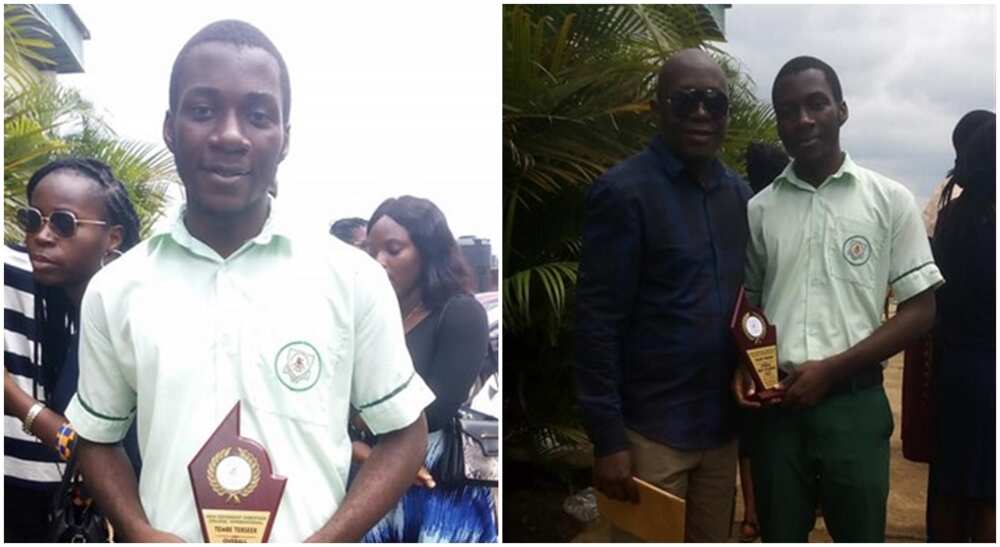 Nigerian secondary school student holding award plaque and standing with a man.