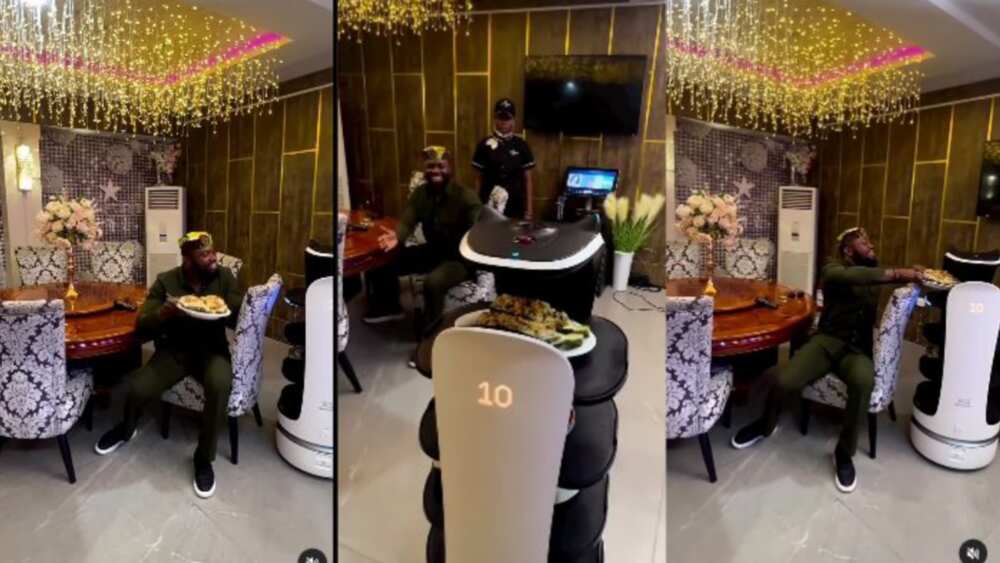 Man receives food from robot at restaurant Man receives food from robot at restaurant