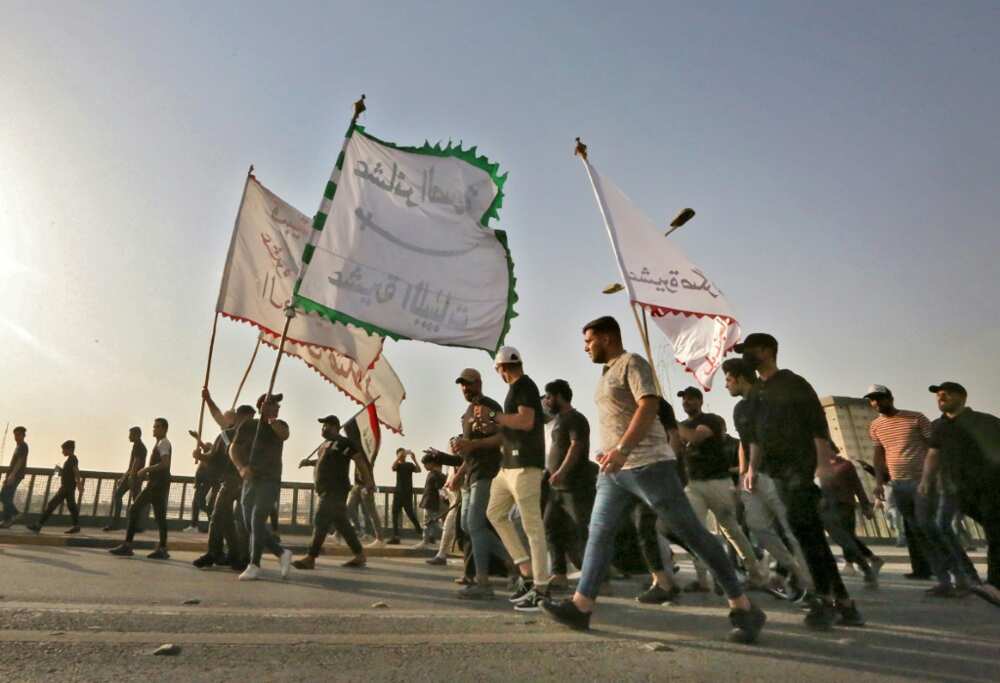 Supporters of Iraqi cleric Moqtada Sadr wave flags during a rally protesting a rival political bloc's nomination for prime minister on Monday Supporters of Iraqi cleric Moqtada Sadr wave flags during a rally protesting a rival political bloc's nomination for prime minister on Monday