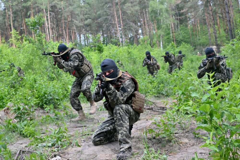 Wielding rifles and wearing balaclavas, the volunteers are trained by the Ukrainian army