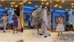 No be juju be that? Lady in purple gown transforms into white dress as silver particles rain on her in video
