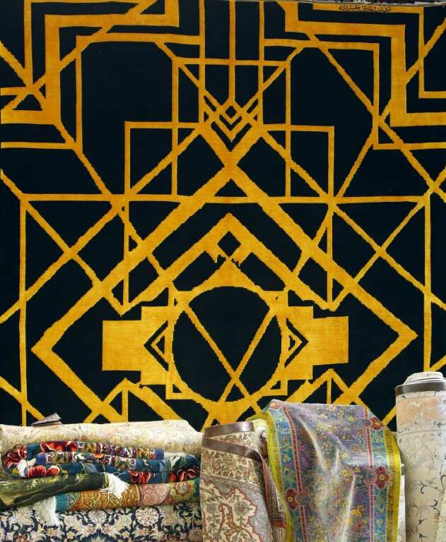 A contemporary geometric design of silk on wool hangs at the carpet exhibition