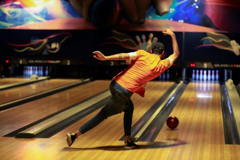 An Iraqi delivers a ball at a bowling alley in Baghdad An Iraqi delivers a ball at a bowling alley in Baghdad