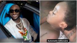 Davido calls his son Ifeanyi an automatic billionaire as little boy sleeps in his arms, Nigerians react