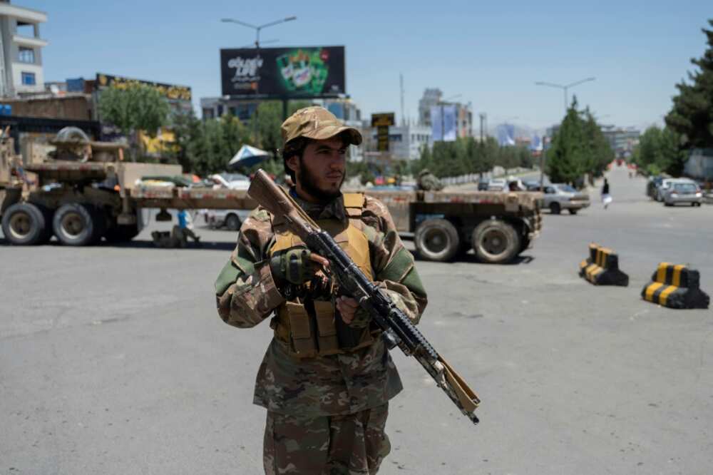 A Taliban fighter stands guard near where thousands of clerics met to discuss Afghanistan's new government