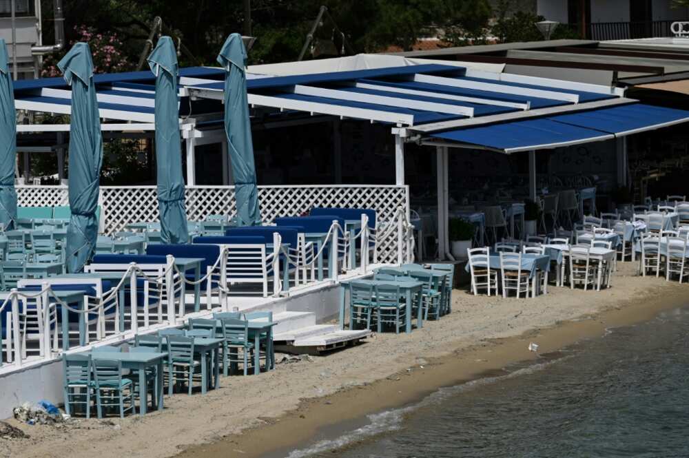 Restaurant tables go right to the water's edge on this beach in Halkidiki in northern Greece