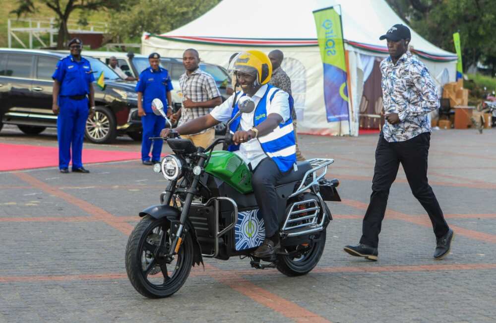 Kenyan President William Ruto takes a ride on one of the new e-bikes