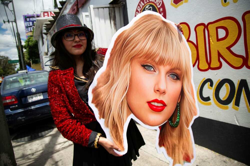 A fan of US superstar Taylor Swift holds a poster with the image of a singer before her presentation at the Foro Sol in Mexico City on August 24, 2023