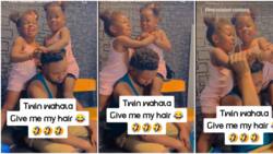 "The man don give up": Nigerian dad helpless in video as his little twin girls fightt over his hair