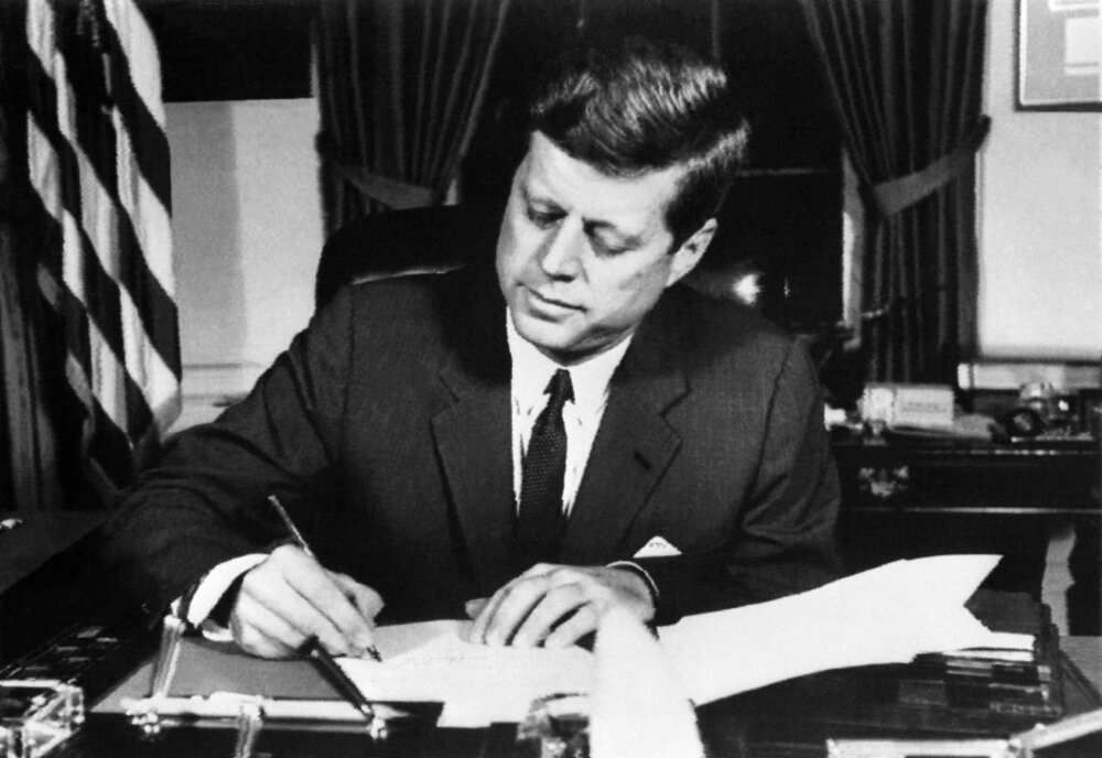 US President John F. Kennedy signs the order of a naval quarantine of Cuba on October 23, 1962 at the White House