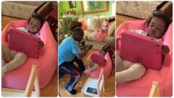 "As it should be": Funny little girl crosses legs on couch, holds tablets as old man feeds her