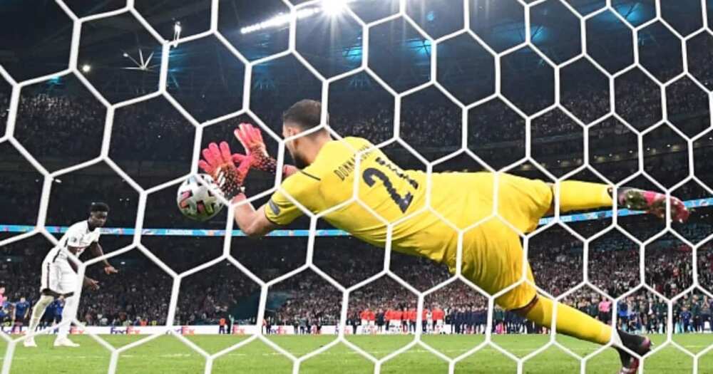 Italy keeper Donnarrumma saves Saka's crucial penalty. Photo by Paul ELLIS.