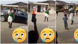 "Money dey buy money": Woman with her baby on her back sings and dances on road about new naira, video trends