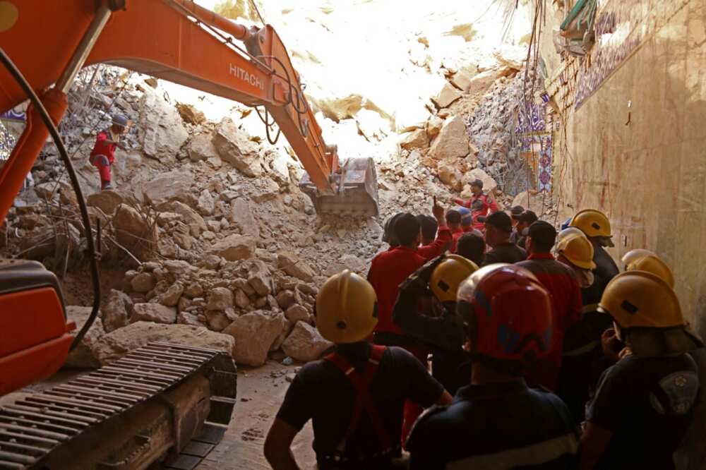 Rescuers used a backhoe and bulldozer to search the rubble for victims at Qattarat al-Imam Ali shrine in Karbala, Iraq