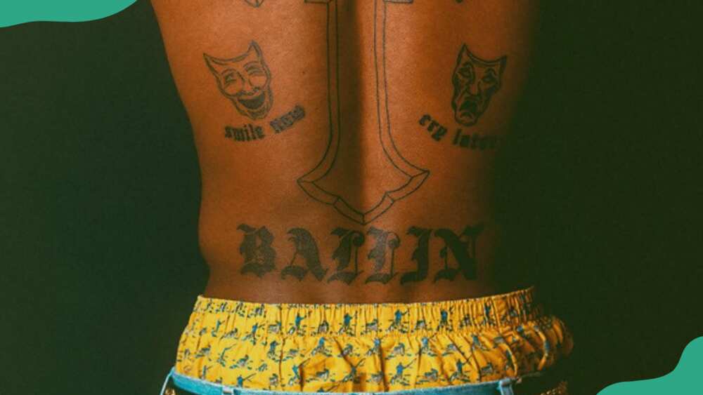 BALLIN tatt on his lower back