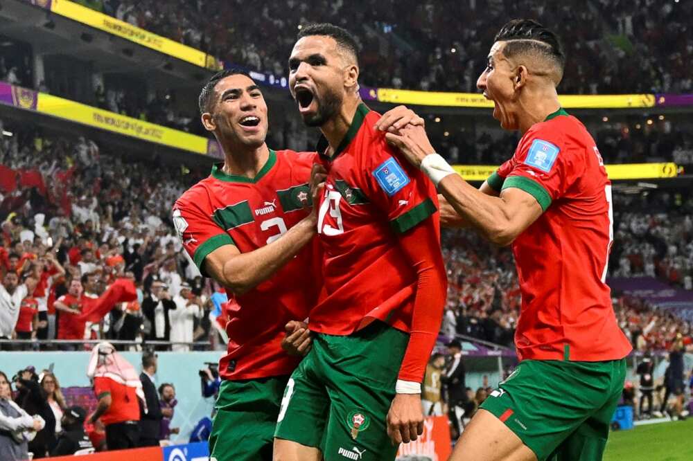 Moroccan forward Youssef En-Nesyri (C) celebrates after scoring during the 2022 World Cup
