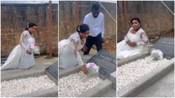 Bride visits father's grave in her white wedding gown, cries as she poses for photos
