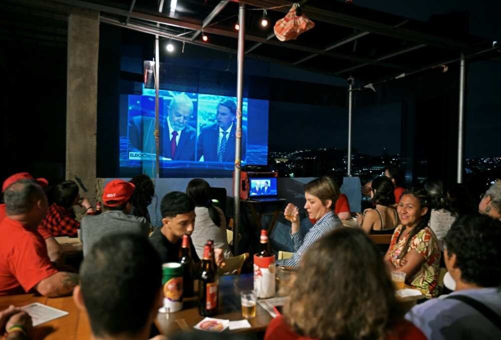 Disinformation wars on TV: Brazilians watch a presidential debate between incumbent Jair Bolsonaro and front-runner Luiz Inacio Lula da Silva at a Rio de Janeiro bar on August 29