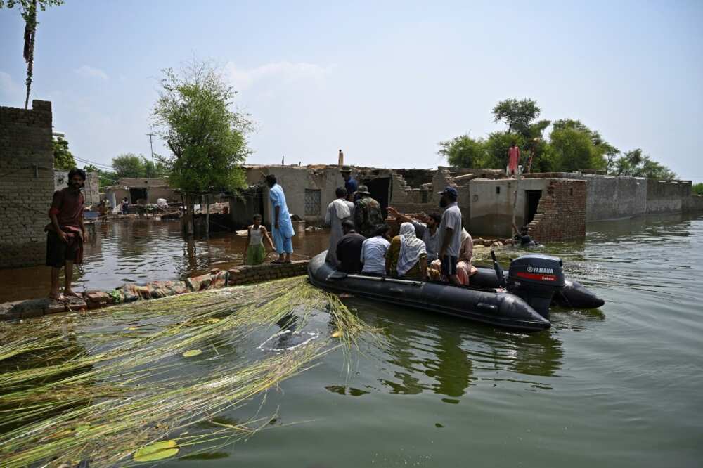 Pakistan navy servicemen try to persuade villagers to evacuate their homes in Dadu, Sindh province