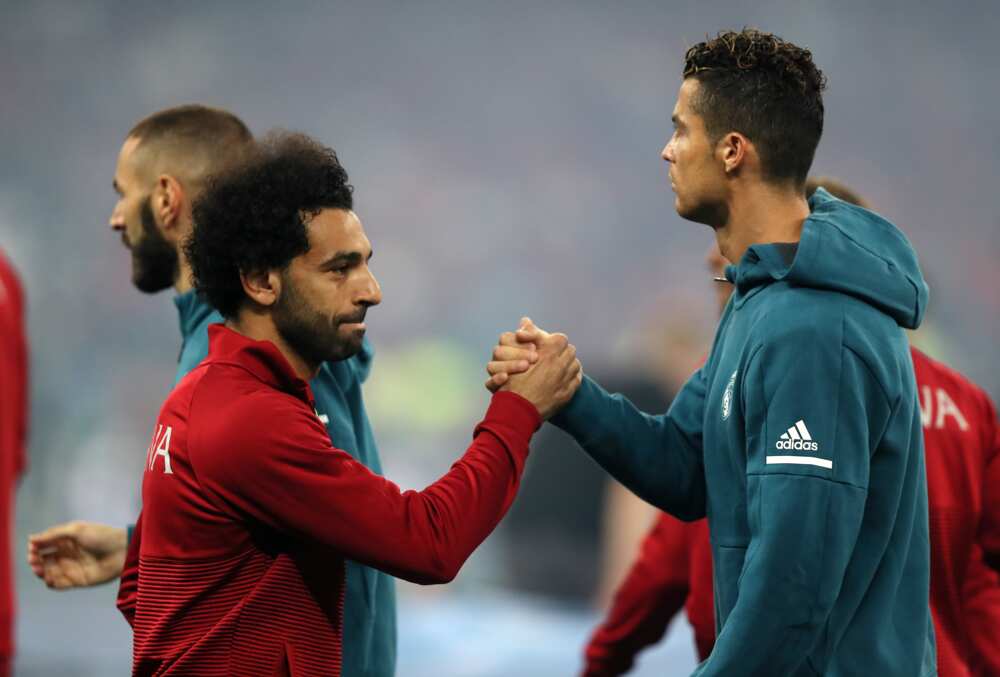 Mohamed Salah of Liverpool and Cristiano Ronaldo in action
