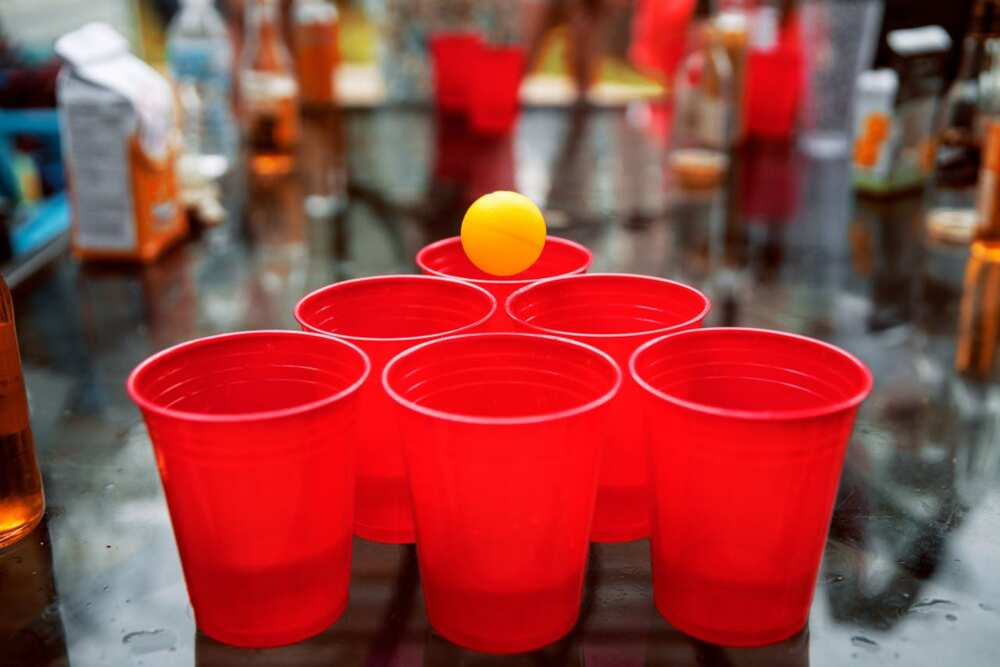 Party cups with a small yellow ball on the surface