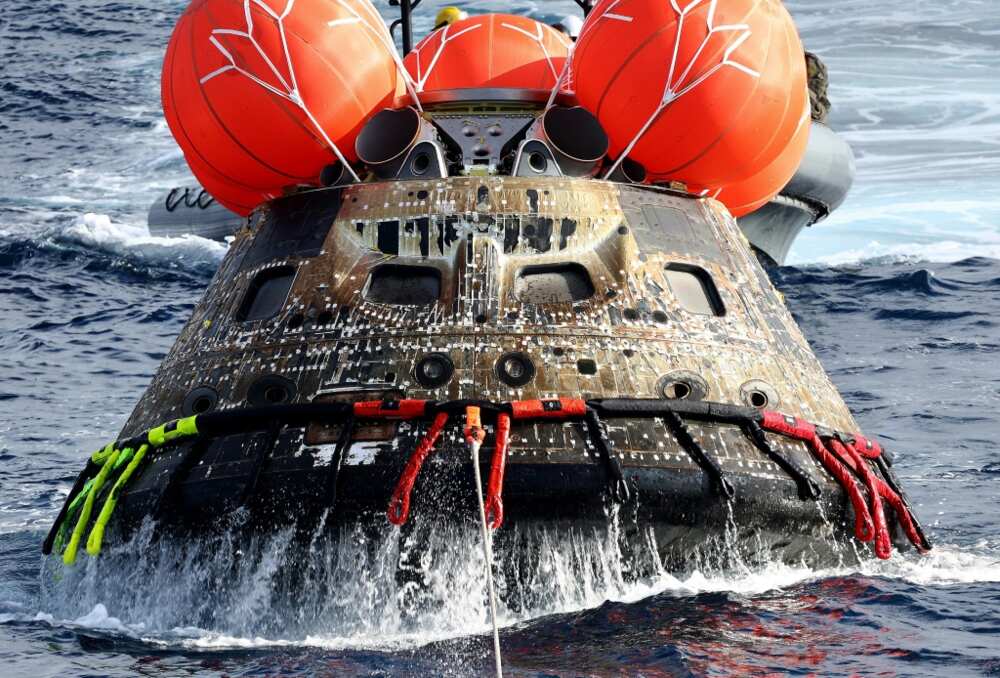 NASA's Orion space capsule being retrieved after splashing down in the Pacific Ocean