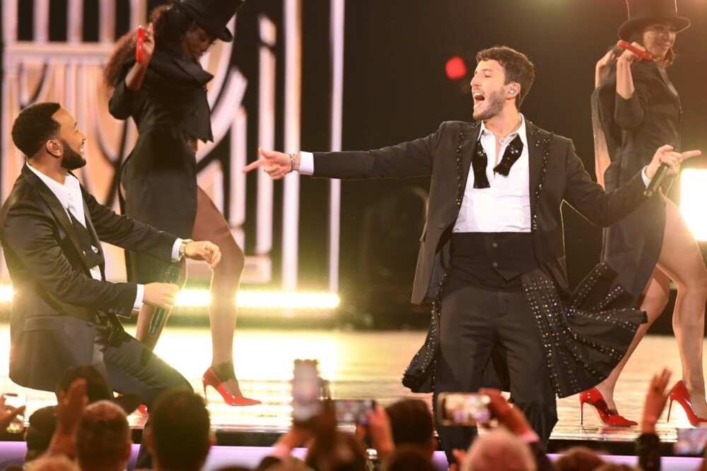 Colombian singer Sebastian Yatra (R) and US singer-songwriter John Legend perform on stage during the 23rd Annual Latin Grammy awards at the Mandalay Bay's Michelob Ultra Arena in Las Vegas, Nevada, on November 17, 2022