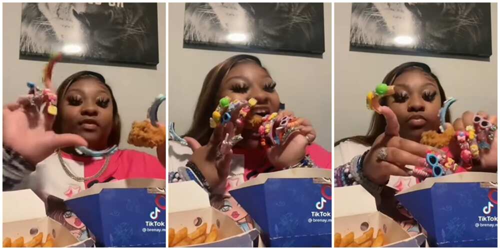 Lady eating chicken with long nails.