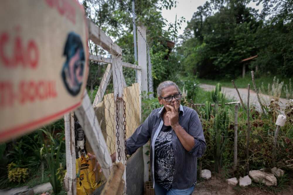 Joaquina de Oliveira is among the few residents still living in the devastated neighborhood of Parque da Cachoeira