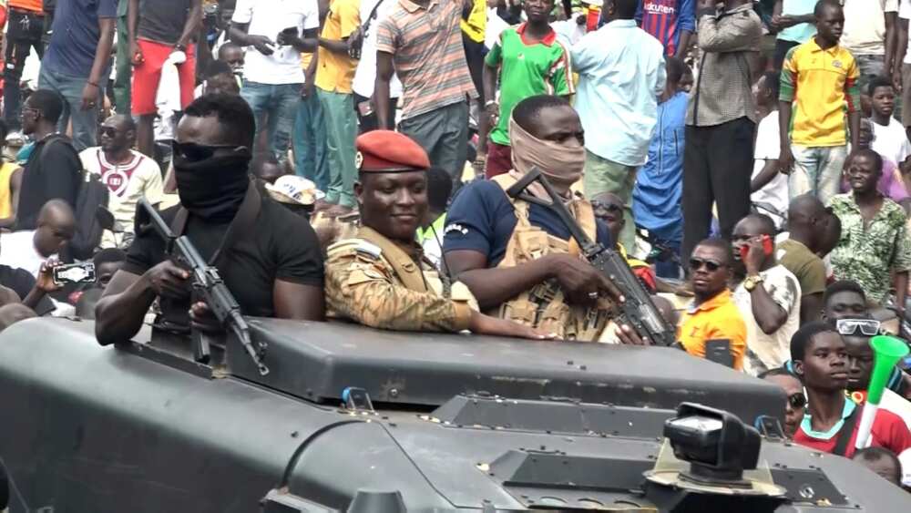 Captain Ibrahim Traore (C), parades in the streets of Ouagadougou and hails the cheering crowd after the latest Burkina Faso coup