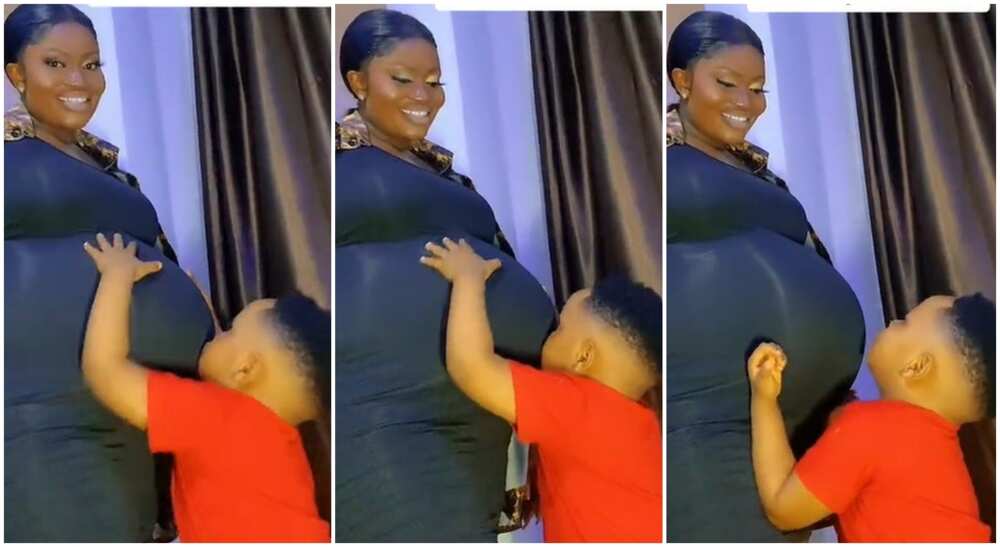Photos of adorable black boy admiring his mum's cute baby bump.