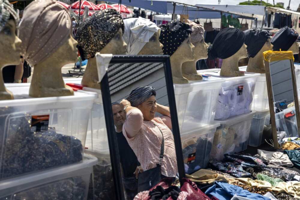 A girl stores at a low price market on a boulevard within the southern Israeli city of Ashkelon A girl stores at a low price market on a boulevard within the southern Israeli city of Ashkelon