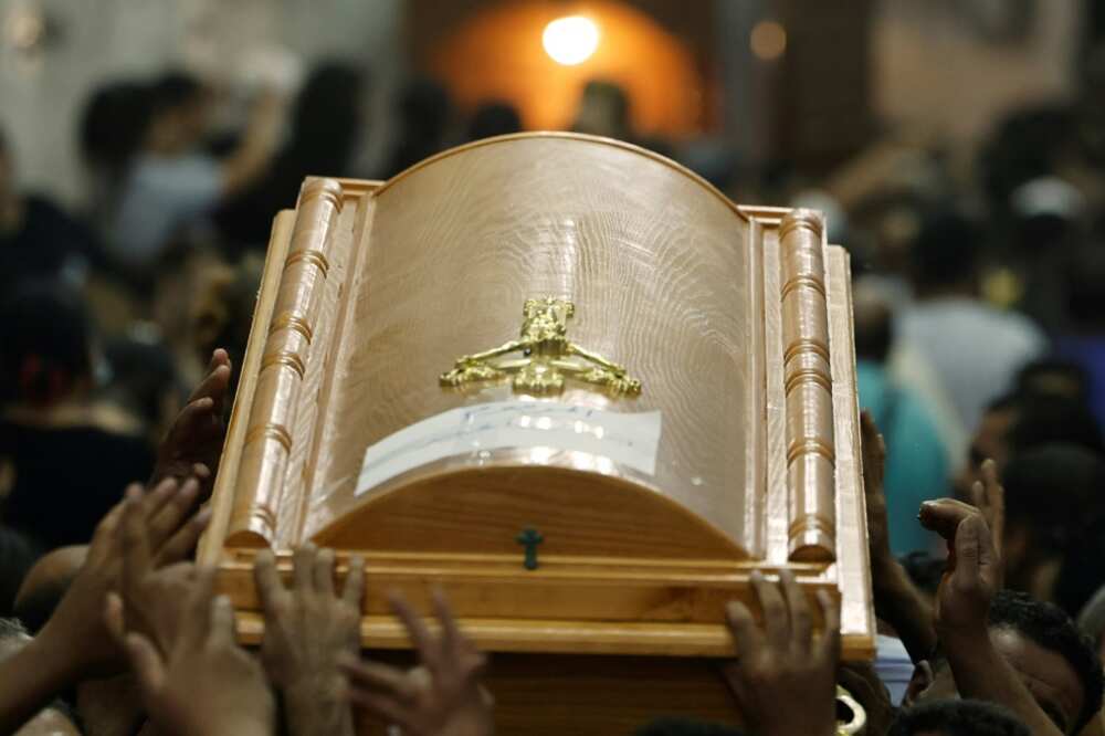 Egyptian mourners carry the coffin of a child killed in the Cairo Coptic church fire at the Church of the Blessed Virgin Mary in Giza Governorate on August 14, 2022