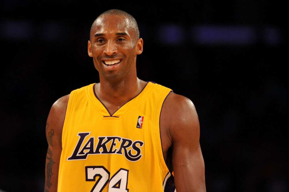 Kobe Bryant smiles in a Los Angeles Lakers jersey