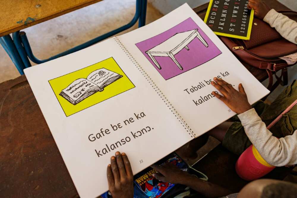 Girls using a book to learn Bambara, one of Mali’s national languages
