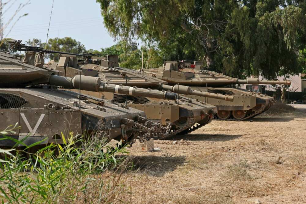 Israeli tanks deploy along the Gaza border as the army places more restrictions on the movement of Israeli civilians in communities nearby