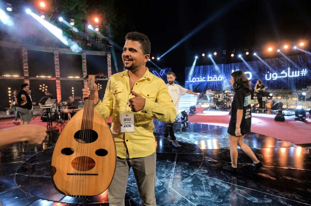 Palestinian musician Ahmed al-Qrinawi holding his oud Palestinian musician Ahmed al-Qrinawi holding his oud