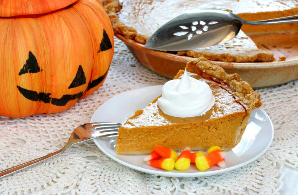 One slice of pumpkin pie with Halloween decorations.