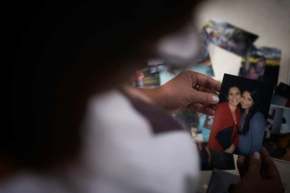 Tania de Oliveira shows a picture of her cousin Nathalia, one of the victims who remain missing five years after a mine dam collapse in the Brazilian town of Brumadinho