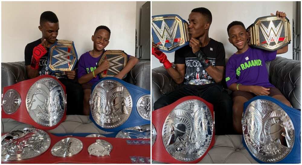 Photos of two Nigerian TikTokers, the Dikeh brothers holding WWE title belts.