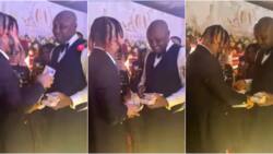 "Isreal really cash out for this wedding o": Reactions as Poco Lee rains money on Davido's PA on his big day